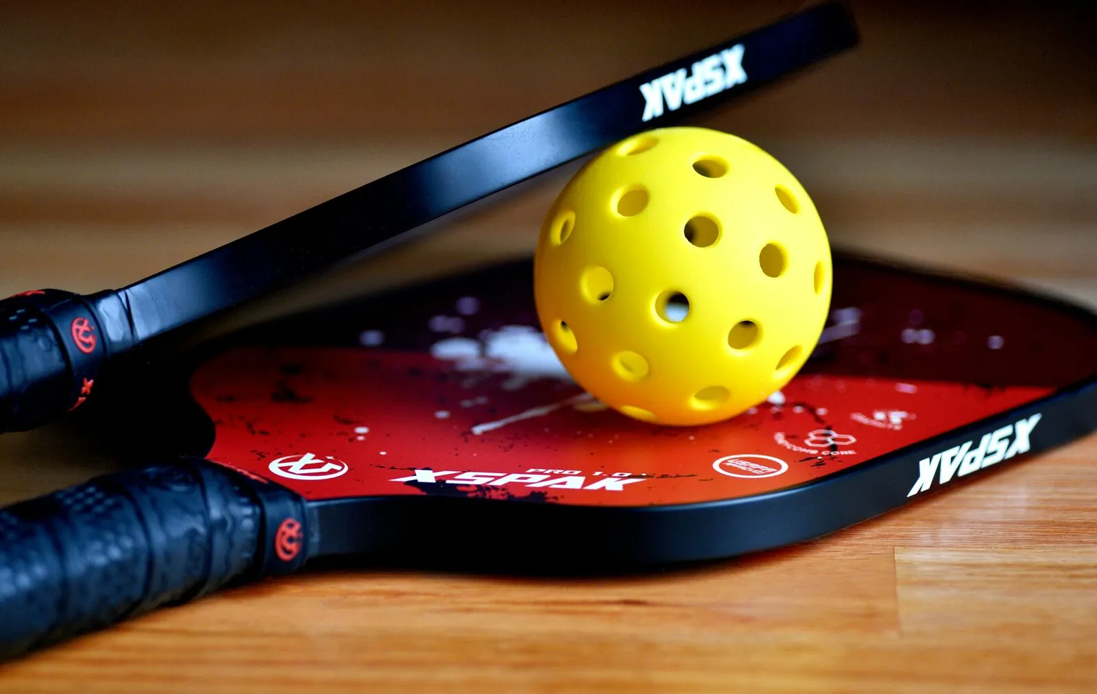 Pickleball paddles and ball at The Social Court